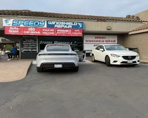 The Speedy Windshield Repair storefront in San Diego with vehicles parked outside