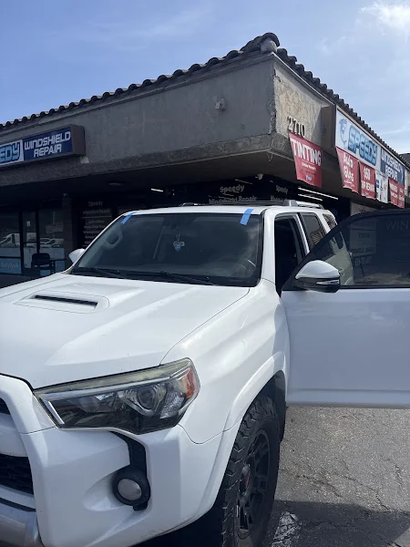 Retention tape holding the moulding on a freshly fitted windshield in a white Toyota 4Runner