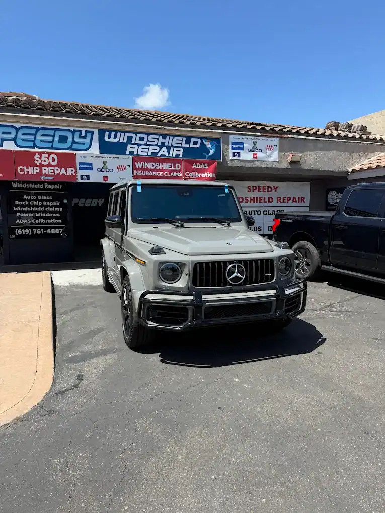 Mercedes G-Class parked outside the Speedy Windshield Repair storefront