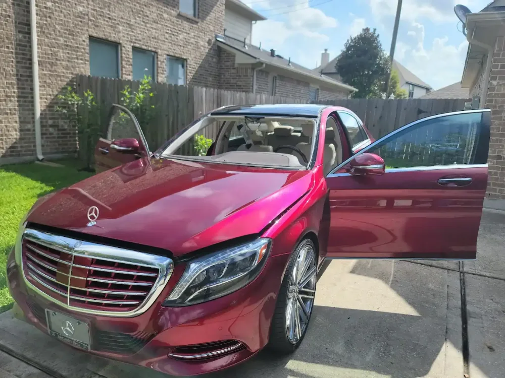 Mercedes S-Class with the driver door open on a residential driveway during a mobile visit