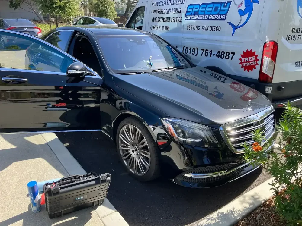 Technician tool case beside a Mercedes S-Class on a driveway with the service van behind it