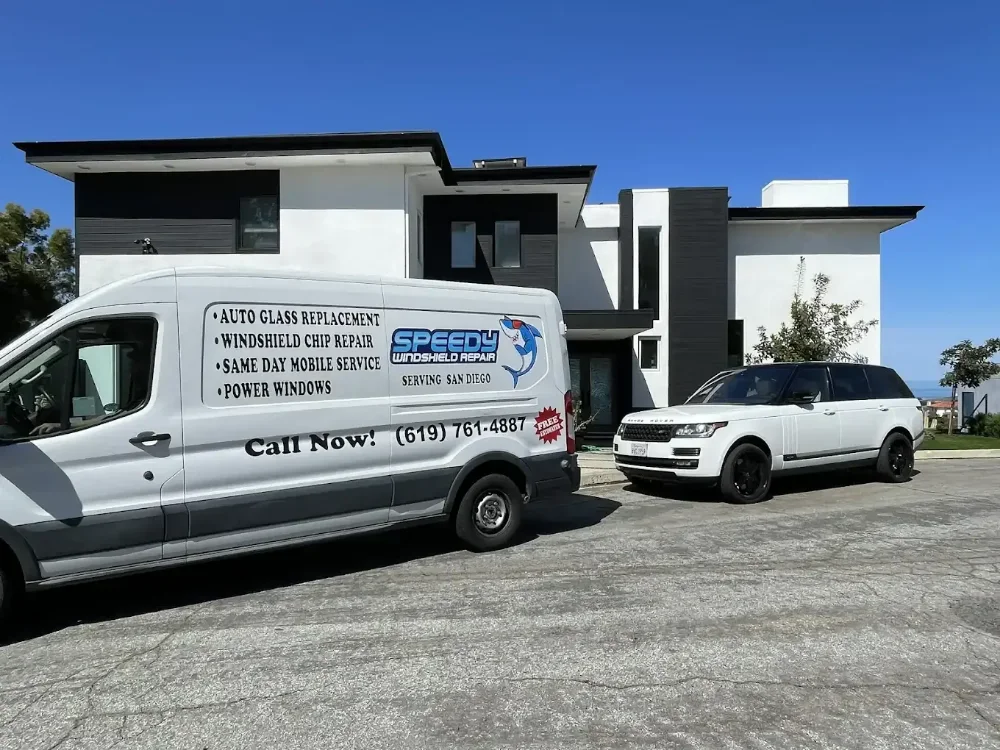 Speedy Windshield Repair service van parked outside a modern home for a mobile auto glass call